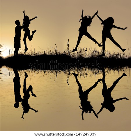 Silhouette of friends jumping in sunset