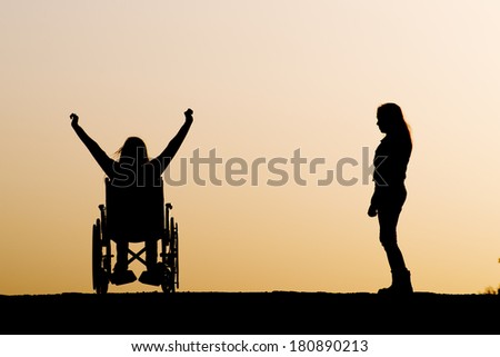 Silhouette of girl on a wheelchair and helping a friend
