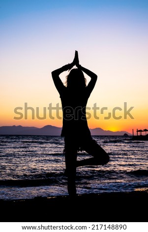 Silhouette Woman Yoga on the beach