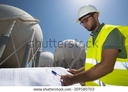 Liquefied Petroleum Gas tanks and Petrochemical Engineer. petrochemical engineer preparing the project of  fuel tank