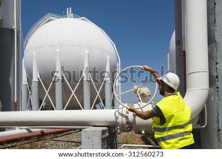 Liquefied Petroleum Gas tanks and Petrochemical Engineer. Engineers opens the gas valve