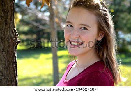Portrait of pretty young woman outside on college campus in the Fall