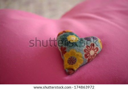 Floral heart bean bag on pink heart pillow background