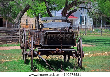 Old Wagon In Front Of An Old Farmhouse