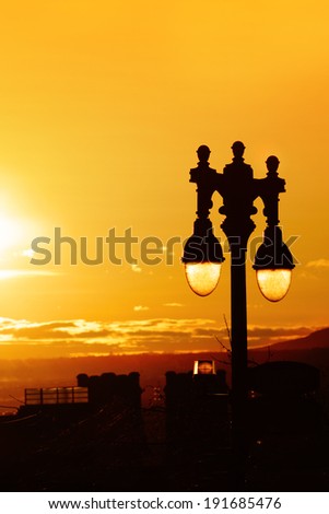 Close up on Streetlight lantern at sundown with yellow sky, Quebec, city