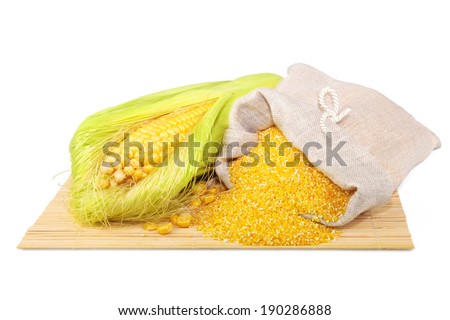 Composition from corn and maize flour in flax sack on the mat isolated on white background