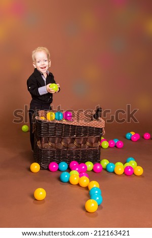 Portrait of smiling boy with small balls in the basket