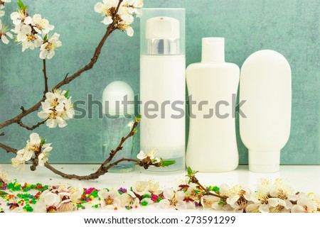 Spring composition with body care products, color candy and spring blossom