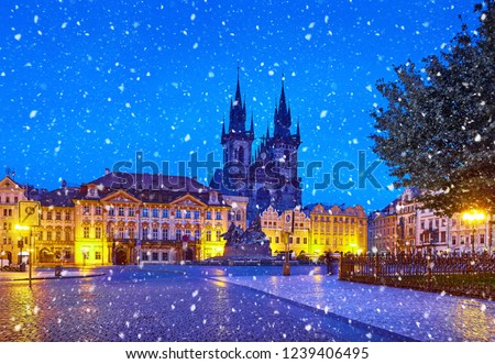 Prague, Czech Republic Central Old Town square in old town. Night view at Church of Our Lady Before Tyn with nighttime illumination. Christmas holiday. Winter snowfall and blue sky.