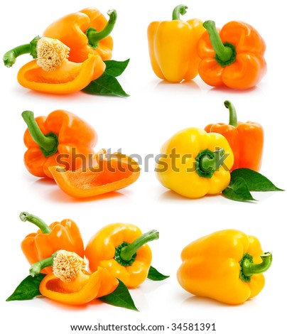 set of fresh yellow orange peppers with cut and green leaves isolated on white background