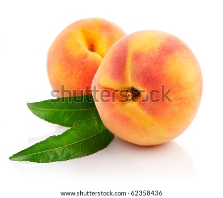 ripe peach fruits with green leaves isolated on white background