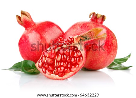 pomegranate fresh fruits with cut and green leaves isolated on white background