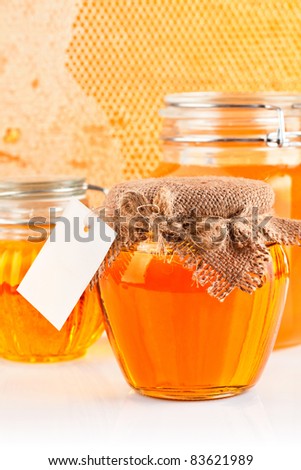 sweet honey in glass jars isolated on white background