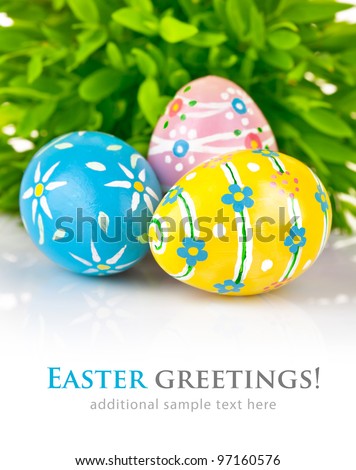 Easter eggs in the green grass isolated on white background