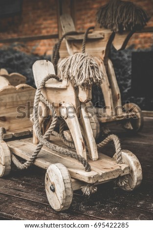 Wooden retro toy handmade horse with wheels and rope traditional joinery craft.
