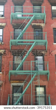 Fire stair outside a building crossing windows