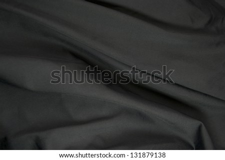 Folds of black silk background