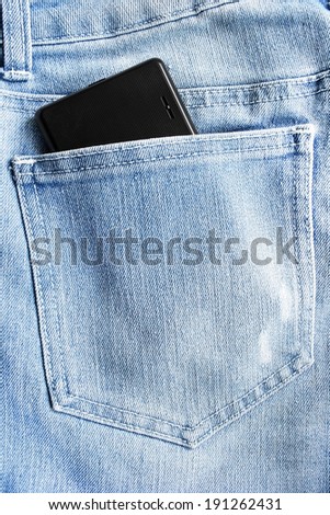 Black mobil phone in a jeans hip pocket