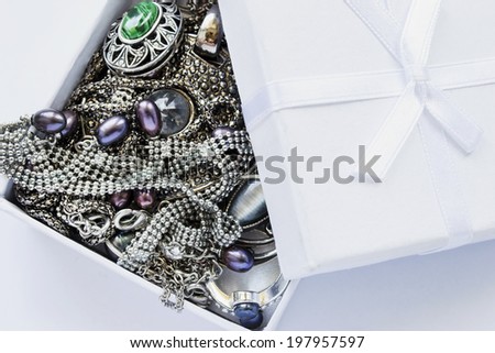 A lot of jewels in white opened box closeup as a background