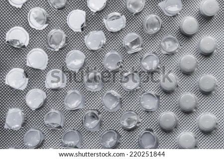 Half empty white pills blister closeup as a background