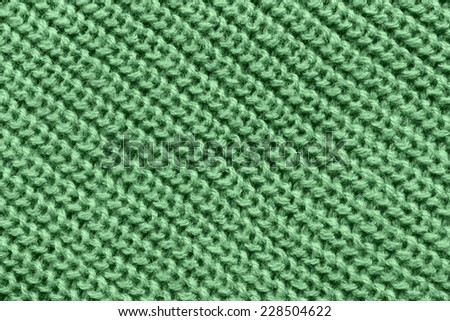 Simple green knitting closeup as a background