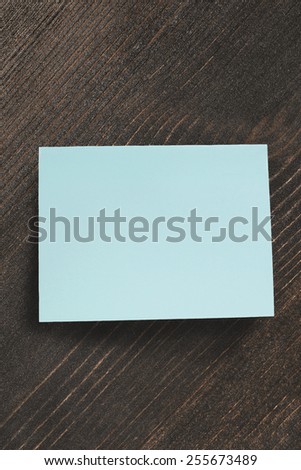 Blue blank sticker over brown wooden background