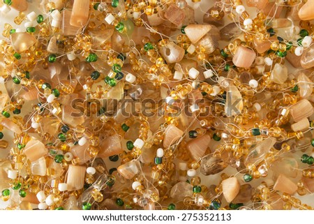Golden and green beads closeup as a background