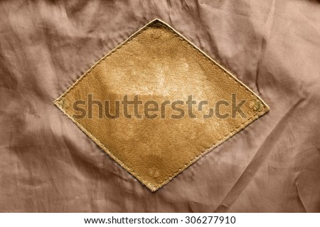 Blank leather clothes label as a background