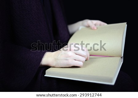 female hands holding an open book
