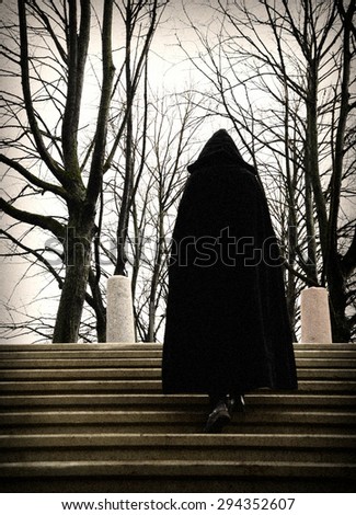 man in a robe climbing stairs