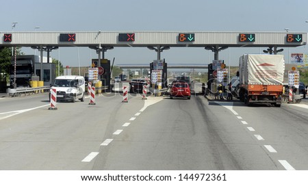 NOVI SAD, SERBIA - CIRCA JULY 2013: Drivers pays road toll at E-75 highway on corridor 10 circa July 2013 in Novi Sad
