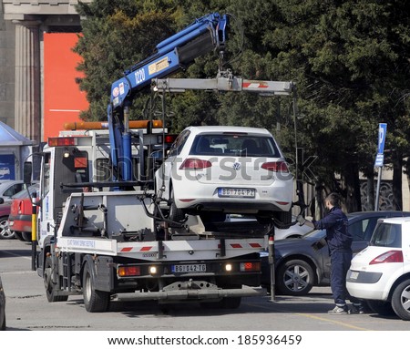 BELGRADE, SERBIA - CIRCA MARCH 2014: Tow truck takes away illegal parked car, circa March 2014 in Belgrade