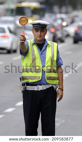 ZRENJANIN, SERBIA - CIRCA AUGUST 2014: Policeman controls drivers at local road, circa August 2014 in Zrenjanin