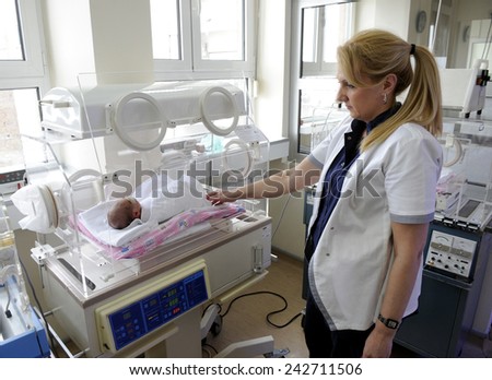 BELGRADE, SERBIA - CIRCA DECEMBER 2014: Nurse takes care of new born babies in maternity hospital, circa December 2014 in Belgrade