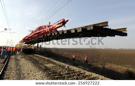 GOLUBINCI, SERBIA - CIRCA FEBRUARY 2015: Workers with heavy machinery repairs rail lines on corridor 10, circa February 2015 in Golubinci