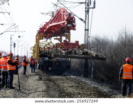 GOLUBINCI, SERBIA - CIRCA FEBRUARY 2015: Workers with heavy machinery repairs rail lines on corridor 10, circa February 2015 in Golubinci