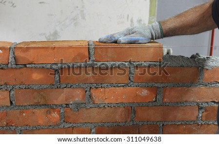 Workers masonry Clay brick to wall
