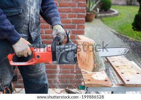 Chain saw cutting wood