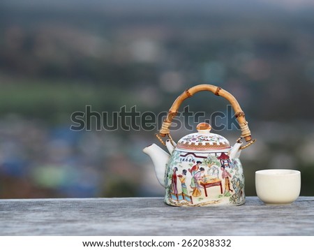 teapot/ceramic teapot on wood table.