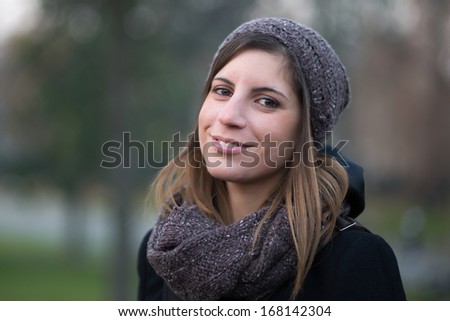 Portrait of beautiful young girl smiling in cold city park- Bologna Giardini Margherita