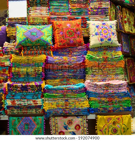Rows of colourful silk scarfs and pillows hanging at a market stall in Istanbul, Turkey - Gran Bazar