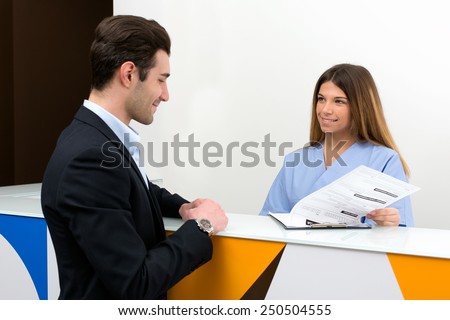 young nurse speaking with client and show him medical information : they discussing together on medical exam at hospital
