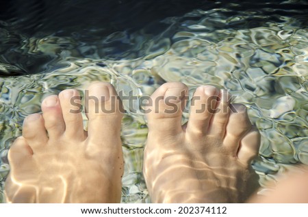 female feet in running water