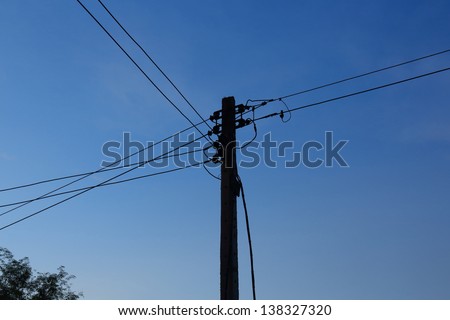 Energy and technology, electrical post with power line cables.