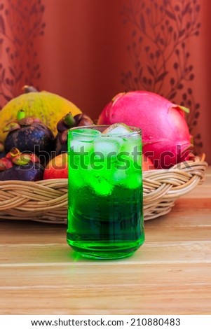 Green Fruit Flavor Soft Drinks with Fruits Background.