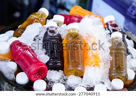 Mixed ice cold juice bottle.
