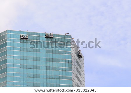 Group of Workers Cleaning Windows Service on High Rise Building.