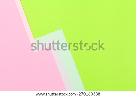 Color papers geometry flat composition background with green and rose tones