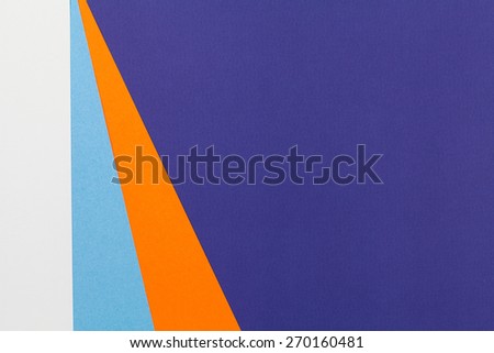Color papers geometry flat composition background with blue grey and orange tones