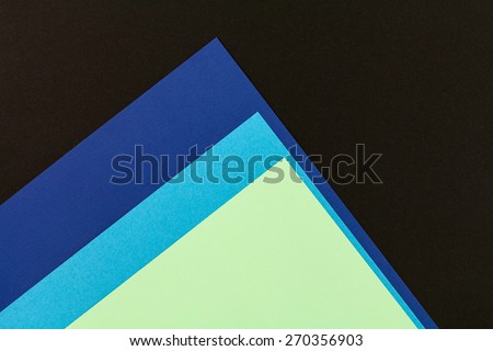 Color papers geometry flat composition background with black and blue tones